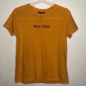 •Yellow shirt with a red logo•